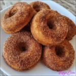 Close-up of cinnamon sugar donut with golden pumpkin interior