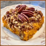 Sliced sweet potato casserole served on a festive plate